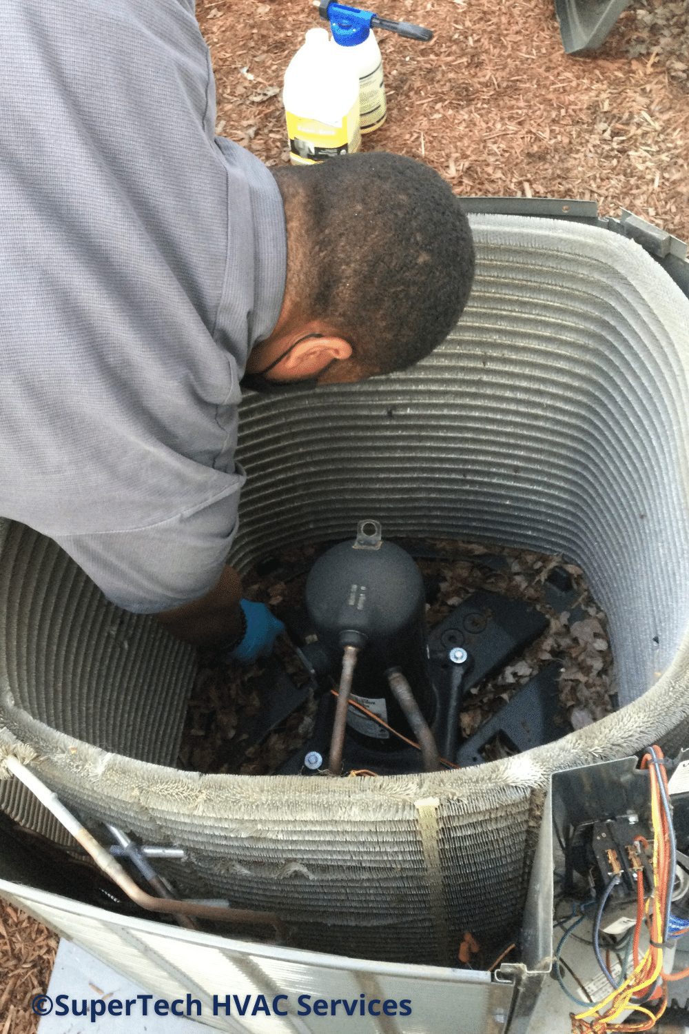 HVAC Pro cleaning out AC condenser HVAC Pro cleaning out AC condenser