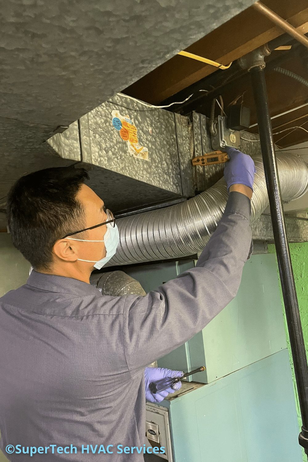 HVAC Pro checking the temperature of the air in your duct system to ensure proper heating and cooling HVAC Pro checking the temperature of the air in your duct system to ensure proper heating and cooling